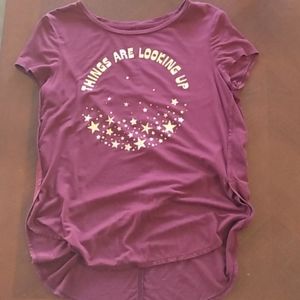 A short sleeve maroon shirt with a long back